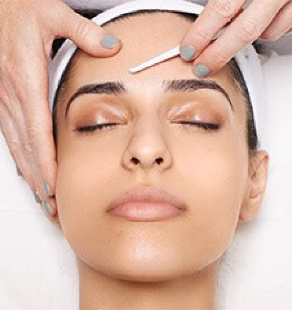 a woman relaxing while undergoing dermaplaning