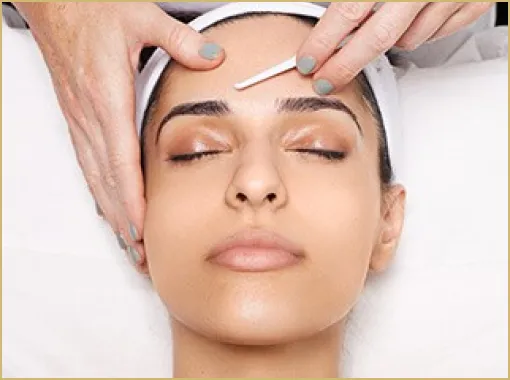 a woman relaxing while undergoing dermaplaning